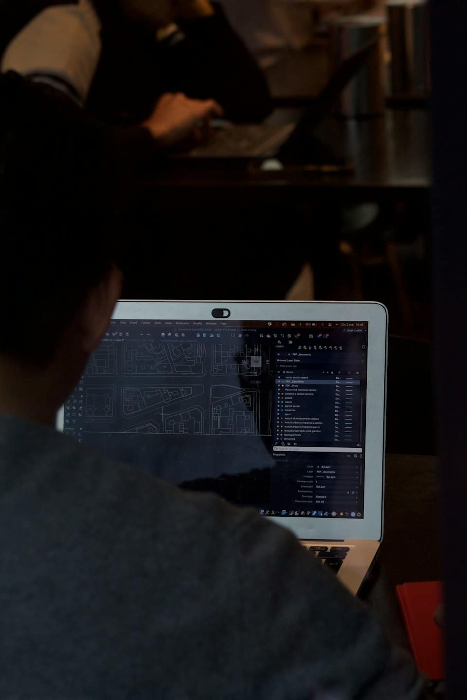 Person working on architectural plans on laptop.